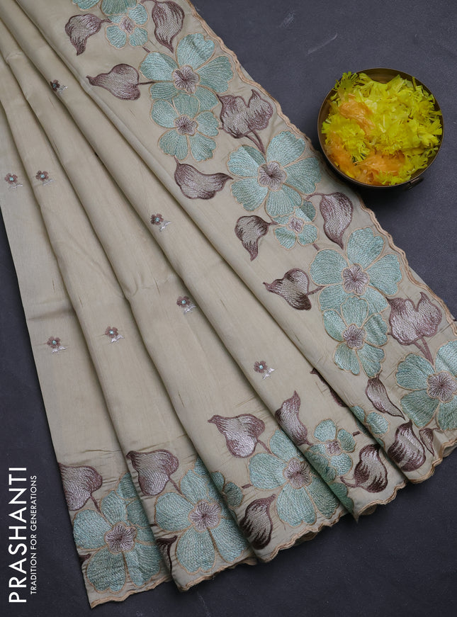 Semi raw silk saree beige with embroidery buttas and floral embroidery border