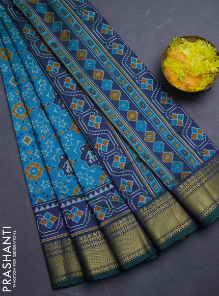 Semi tussar saree dual shade of teal green with allover patola prints and zari woven border