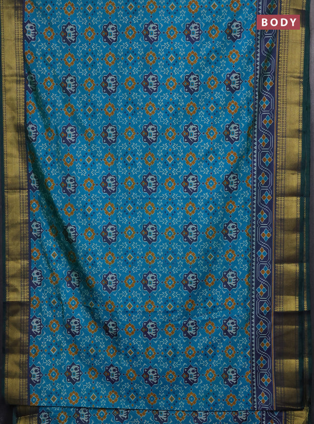 Semi tussar saree dual shade of teal green with allover patola prints and zari woven border