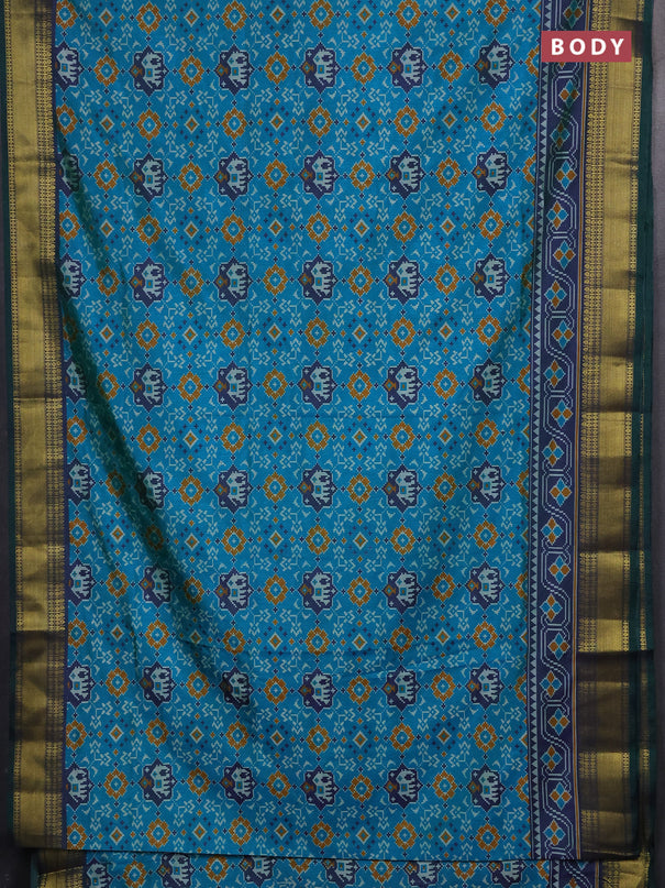 Semi tussar saree dual shade of teal green with allover patola prints and zari woven border