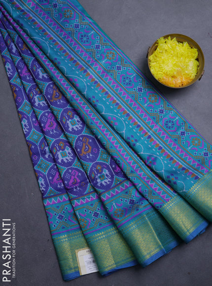 Semi tussar saree blue and teal green with allover patola prints and zari woven border