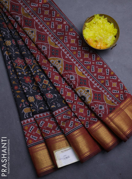 Semi tussar saree black and maroon with allover patola prints and zari woven border