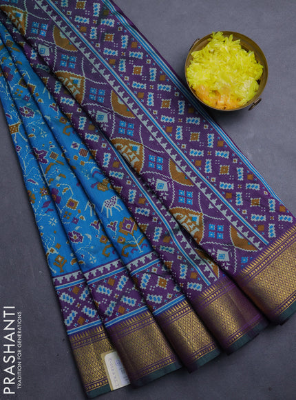 Semi tussar saree teal blue and purple with allover patola prints and zari woven border