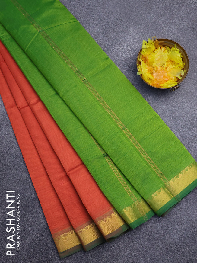 Silk cotton saree rustic orange and light green with plain body and small zari woven border