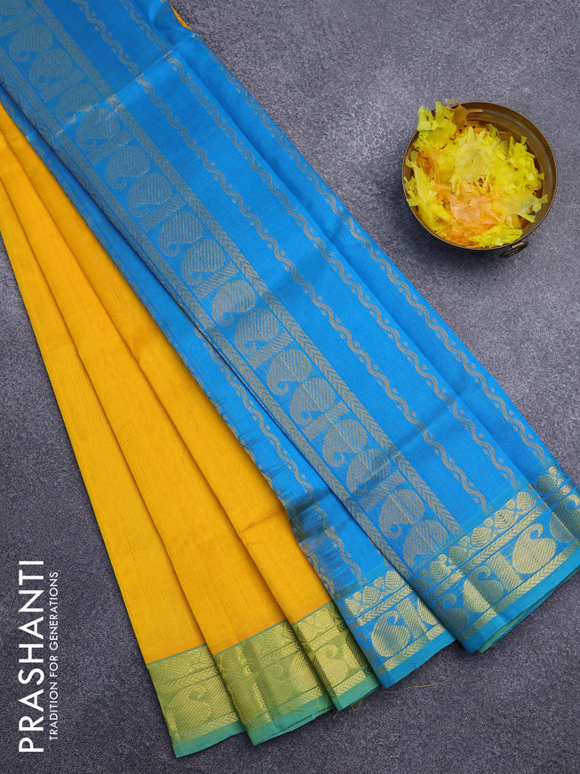 Silk cotton saree yellow and cs blue with plain body and paisley zari woven border