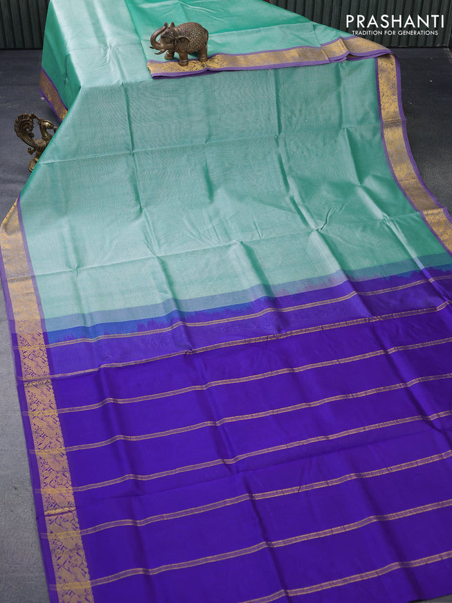 Silk cotton saree teal blue and blue with plain body and peacock zari woven border