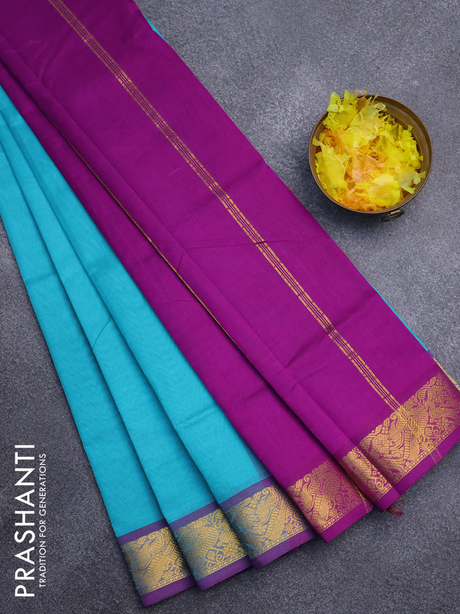 Silk cotton saree teal blue and purple with plain body and peacock zari woven border