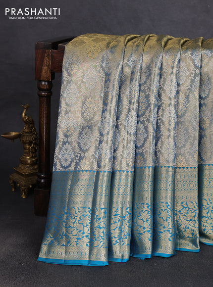 Pure kanchipuram tissue silk saree dual shade of golden blue and peacock green with allover zari woven brocade weaves and rich zari woven border