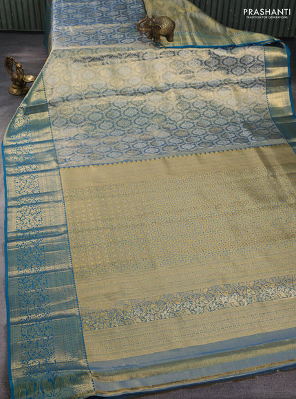 Pure kanchipuram tissue silk saree dual shade of golden blue and peacock green with allover zari woven brocade weaves and rich zari woven border