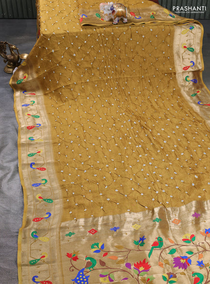 Dola silk saree dark mustard with allover bandhani prints and paithani border