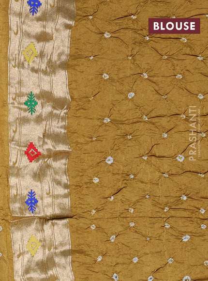 Dola silk saree dark mustard with allover bandhani prints and paithani border
