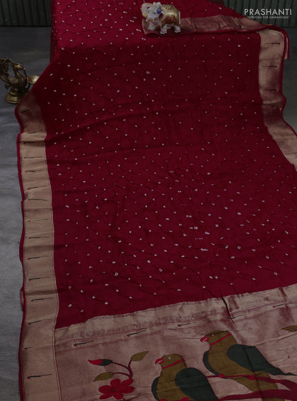 Dola silk saree red with allover bandhani prints and muniya butta border