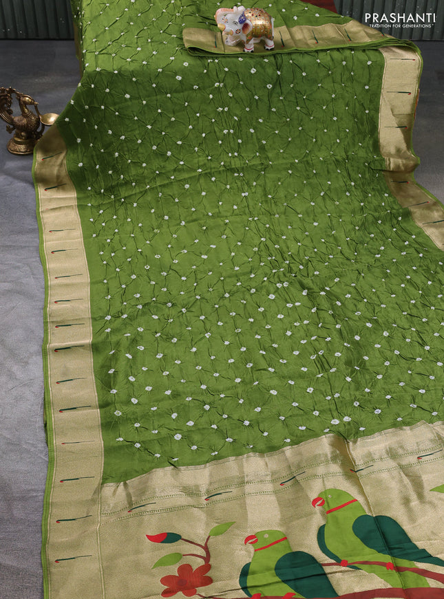 Dola silk saree green shade with allover bandhani prints and muniya butta border