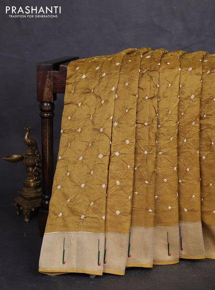 Dola silk saree dark mustard yellow with allover bandhani prints and muniya butta border