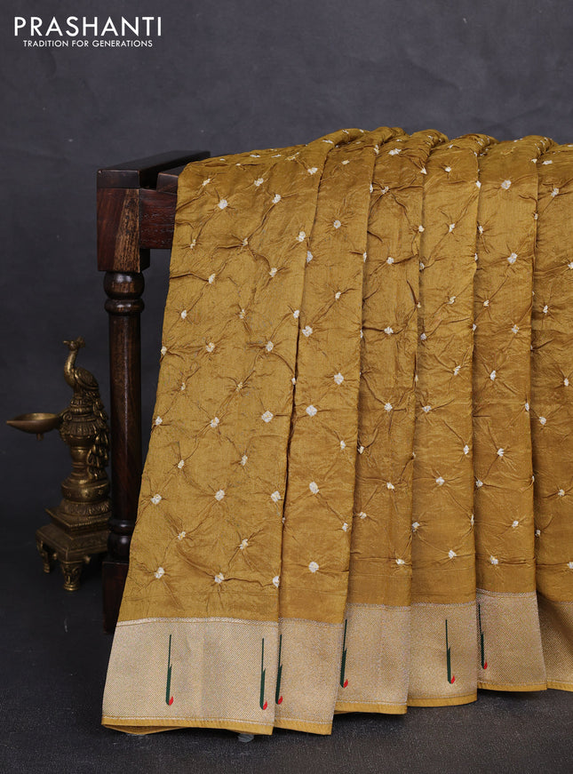 Dola silk saree dark mustard yellow with allover bandhani prints and muniya butta border