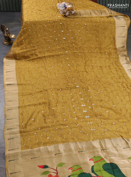 Dola silk saree dark mustard yellow with allover bandhani prints and muniya butta border