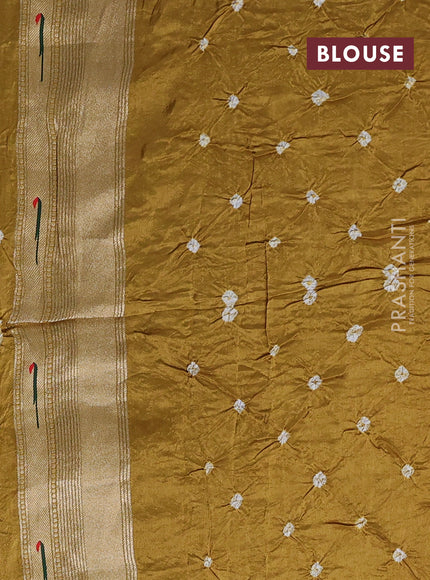 Dola silk saree dark mustard yellow with allover bandhani prints and muniya butta border