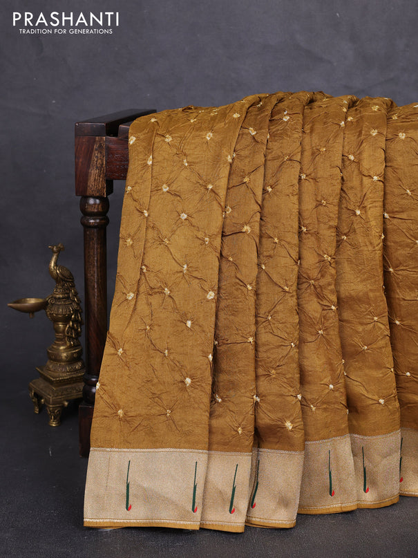 Dola silk saree dark mustard with allover bandhani prints and muniya butta border