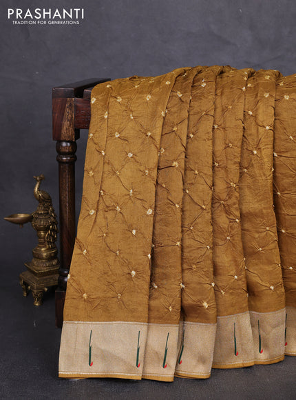 Dola silk saree dark mustard with allover bandhani prints and muniya butta border