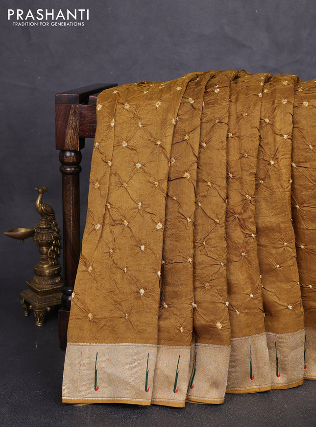 Dola silk saree dark mustard with allover bandhani prints and muniya butta border