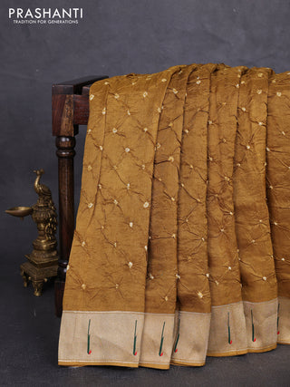 Dola silk saree dark mustard with allover bandhani prints and muniya butta border