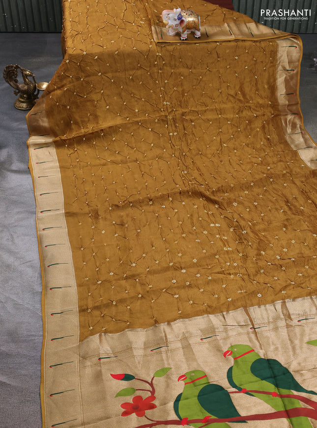 Dola silk saree dark mustard with allover bandhani prints and muniya butta border