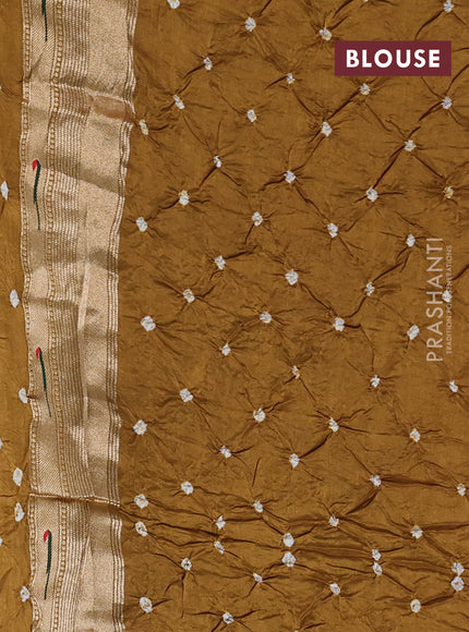 Dola silk saree dark mustard with allover bandhani prints and muniya butta border
