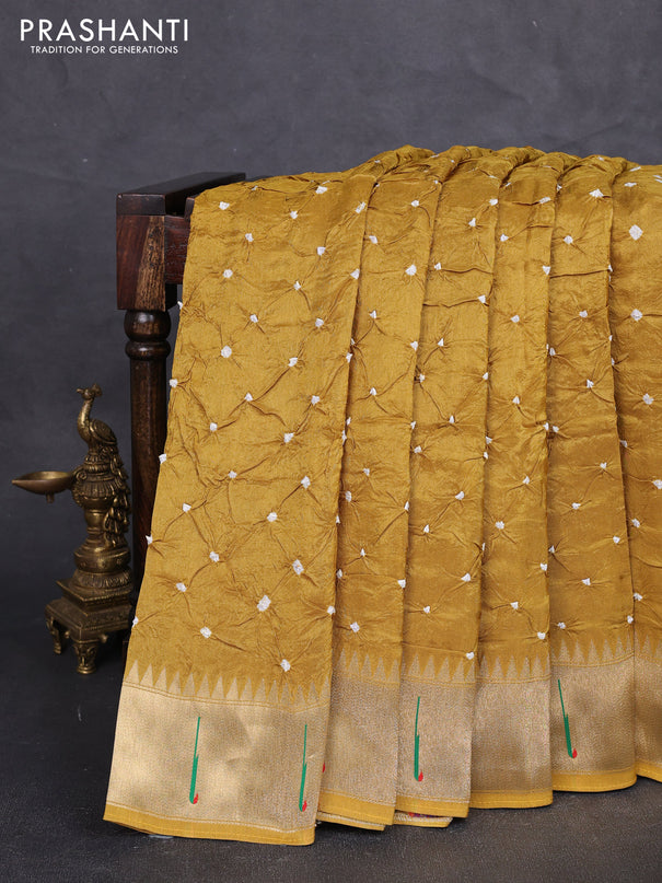 Dola silk saree mustard yellow shade with allover bandhani prints and muniya butta border