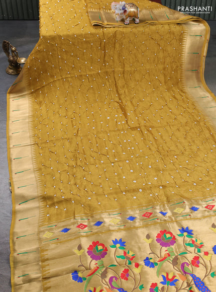 Dola silk saree mustard yellow shade with allover bandhani prints and muniya butta border