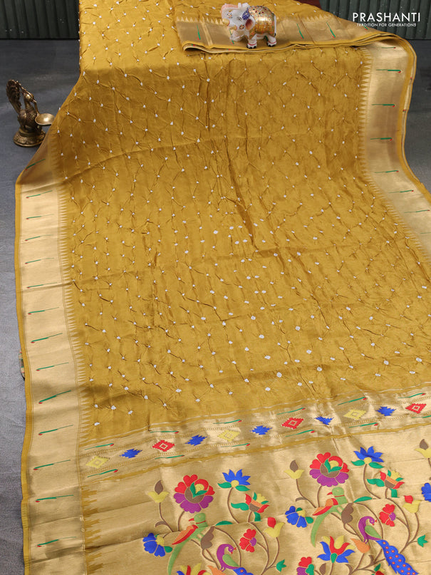 Dola silk saree mustard yellow shade with allover bandhani prints and muniya butta border