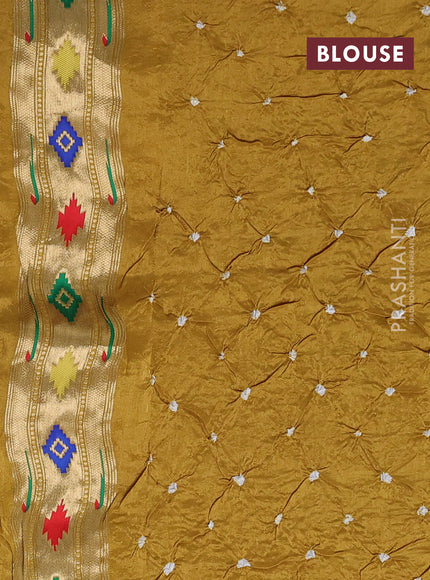 Dola silk saree mustard yellow shade with allover bandhani prints and muniya butta border