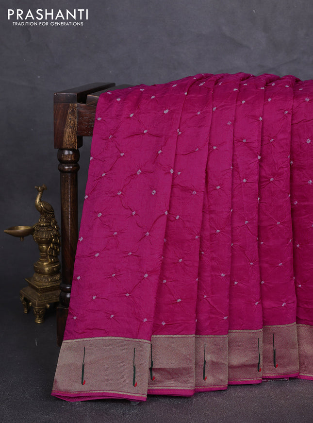 Dola silk saree rani pink with allover bandhani prints and muniya butta border