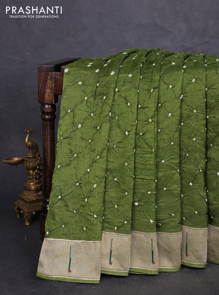 Dola silk saree mehendi green with allover bandhani prints and muniya butta border