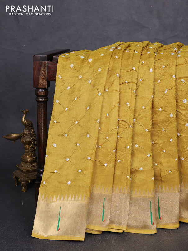 Dola silk saree mustard yellow with allover bandhani prints and muniya butta border