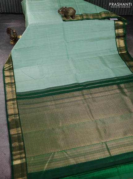 Pure kanchipuram silk saree pastel green and bottle green with allover zari stripe pattern and zari woven korvai border