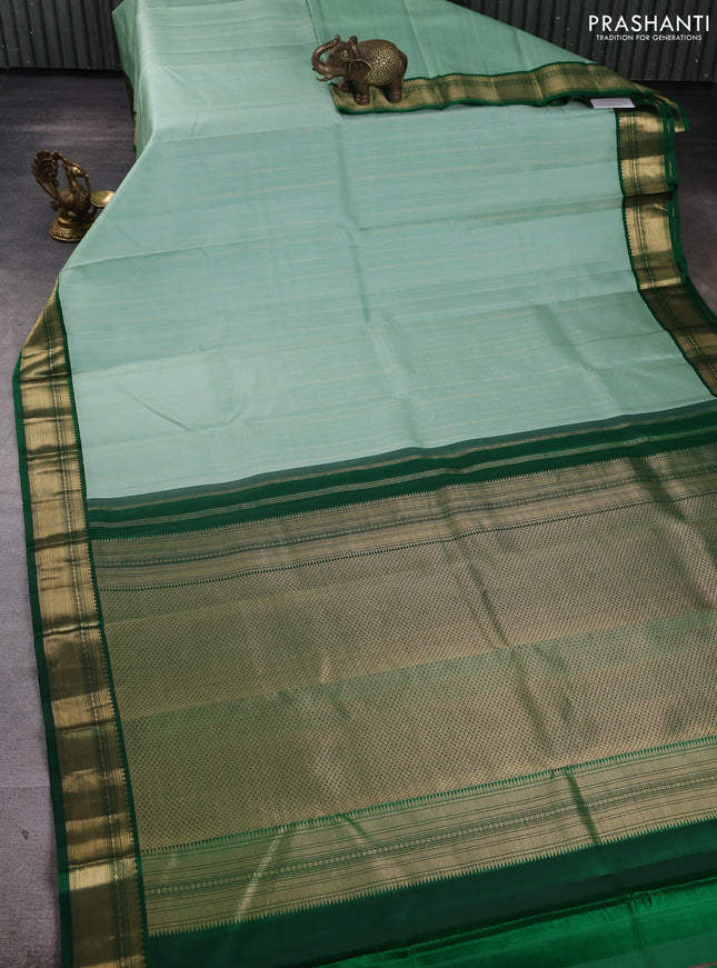 Pure kanchipuram silk saree pastel green and bottle green with allover zari stripe pattern and zari woven korvai border