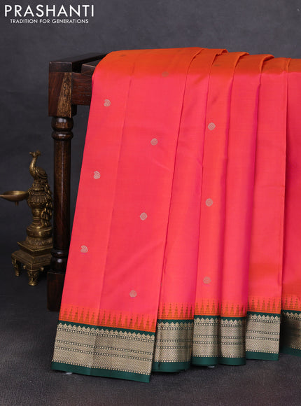 Pure kanchipuram silk saree dual shade of pinkish orange and bottle green with allover zari woven buttas and temple design zari woven korvai border