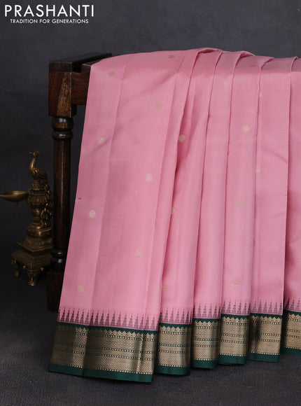 Pure kanchipuram silk saree pastel pink and bottle green with allover zari woven buttas and temple design zari woven korvai border