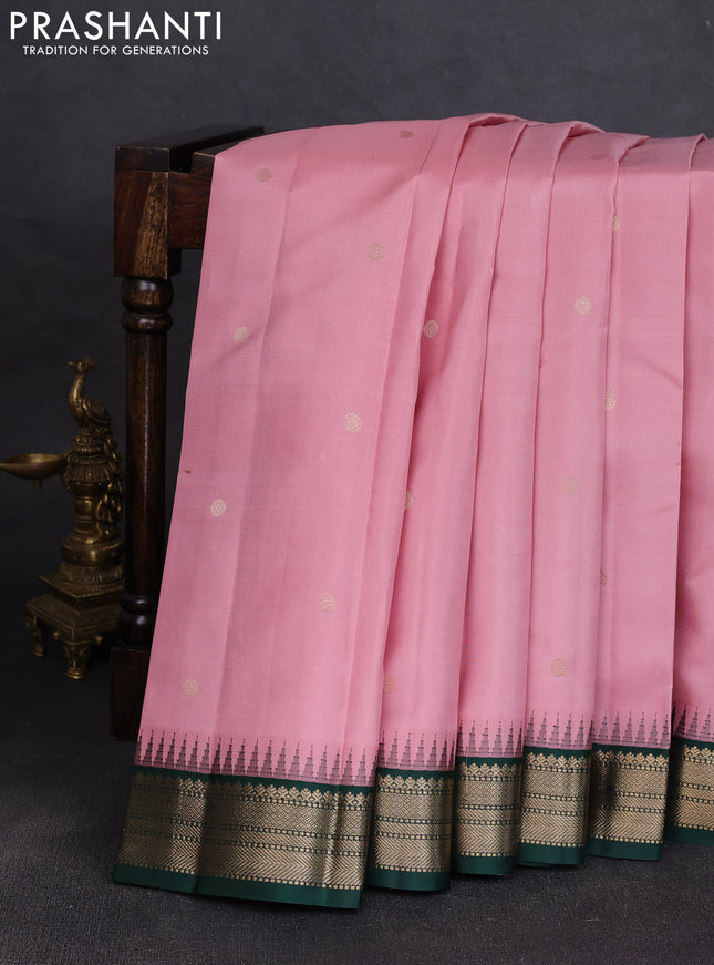 Pure kanchipuram silk saree pastel pink and bottle green with allover zari woven buttas and temple design zari woven korvai border