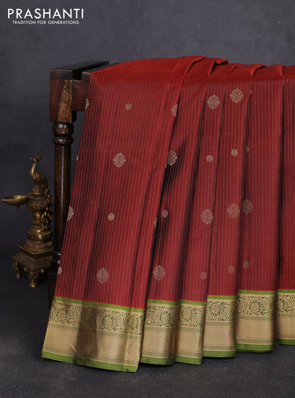 Pure kanchipuram silk saree rust shade and light green with allover zari stripe pattern & buttas and zari woven korvai border