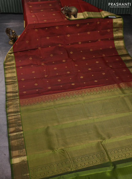 Pure kanchipuram silk saree rust shade and light green with allover zari stripe pattern & buttas and zari woven korvai border