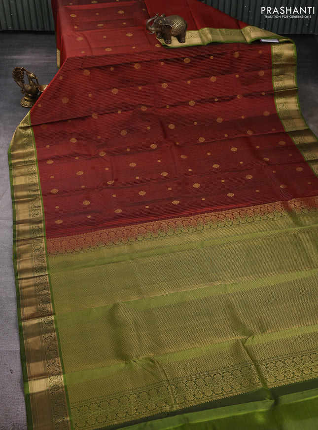 Pure kanchipuram silk saree rust shade and light green with allover zari stripe pattern & buttas and zari woven korvai border