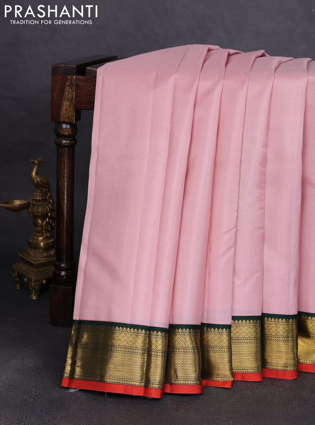 Pure kanchipuram silk saree pastel pink and bottle green wwith allover zari stripe pattern and zari woven korvai border