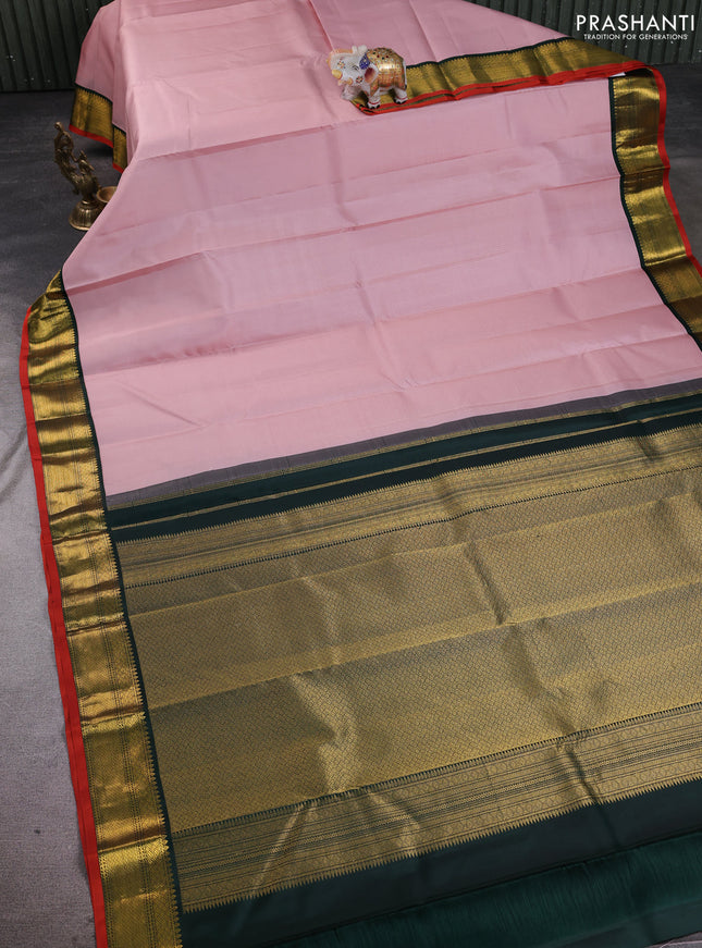 Pure kanchipuram silk saree pastel pink and bottle green wwith allover zari stripe pattern and zari woven korvai border