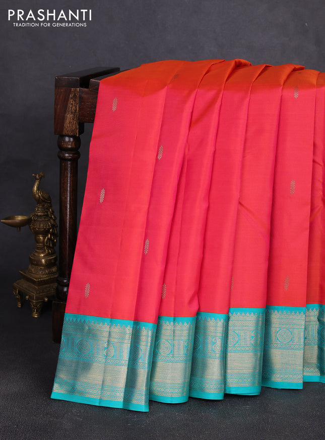 Pure kanchipuram silk saree dual shade of pinkish orange and teal green with zari woven buttas and temple design zari woven korvai border