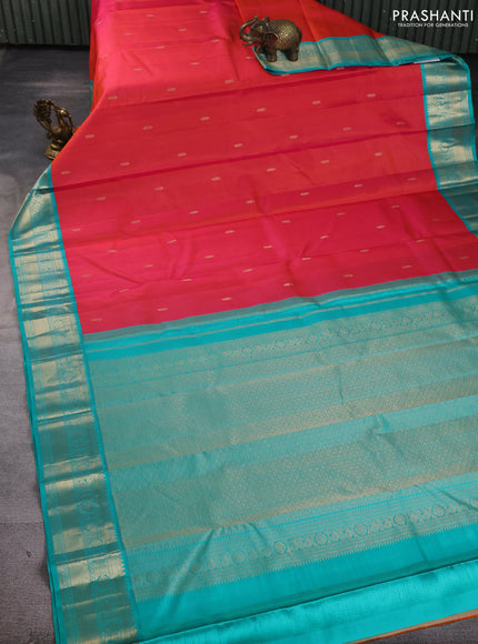 Pure kanchipuram silk saree dual shade of pinkish orange and teal green with zari woven buttas and temple design zari woven korvai border