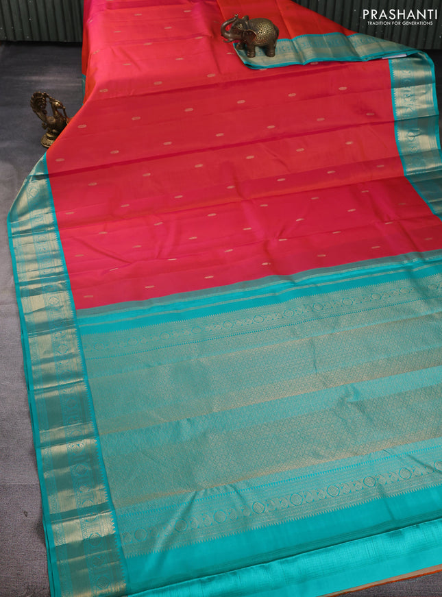 Pure kanchipuram silk saree dual shade of pinkish orange and teal green with zari woven buttas and temple design zari woven korvai border