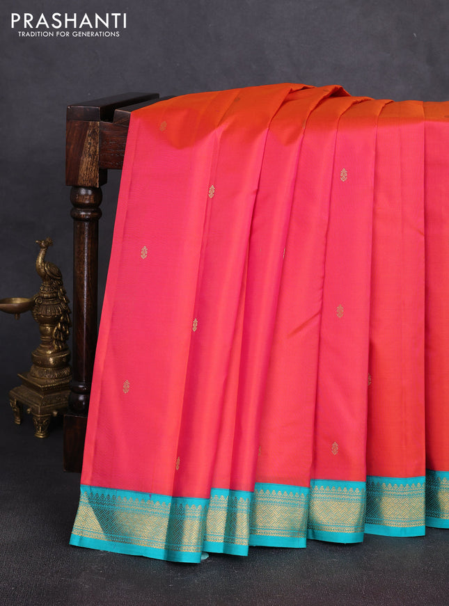 Pure kanchipuram silk saree dual shade of pinkish orange and teal blue with zari woven buttas and zari woven korvai border