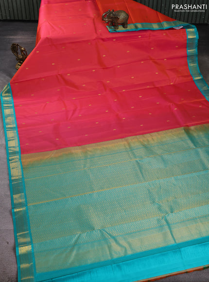 Pure kanchipuram silk saree dual shade of pinkish orange and teal blue with zari woven buttas and zari woven korvai border
