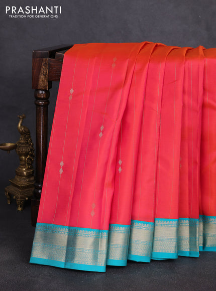Pure kanchipuram silk saree dual shade of pinkish orange and teal blue with allover zari stripe pattern & buttas and zari woven korvai border